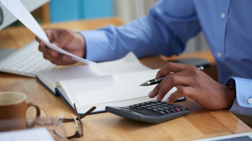 Close-up image of financial managers working with reports