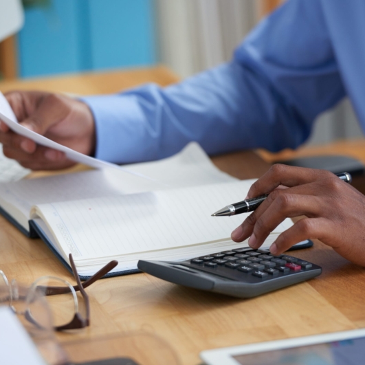 Close-up image of financial managers working with reports